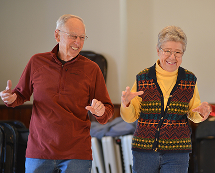 Gary and Anita Girard share a laugh during the warm-up circle at the start of the morning Tai Chi class.