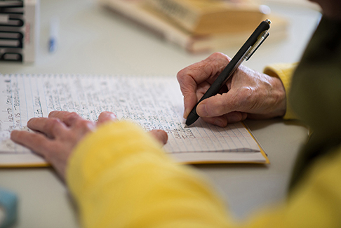 Rusty Pen's Writing Workshop group leader Gayen Thompson, writes in a timed sequence.