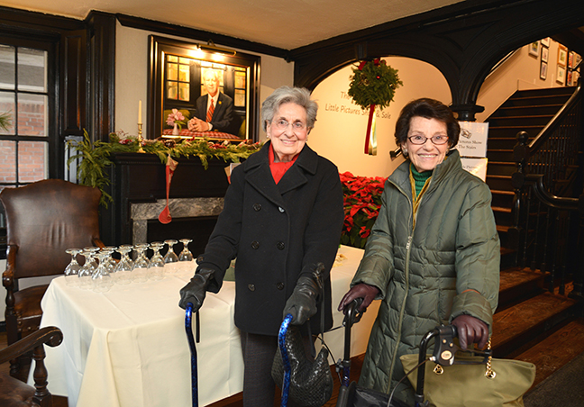 Nan Levine and her friend Judith Litchman chat in the entranceway of
				the Providence Art Club.