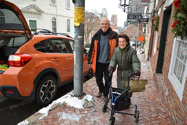 Nan Levine and her friend Judith Litchman are helped to the car by volunteer driver
				Tony Allen after a small luncheon with friends.