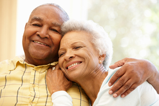 Older couple sharing a laugh at home