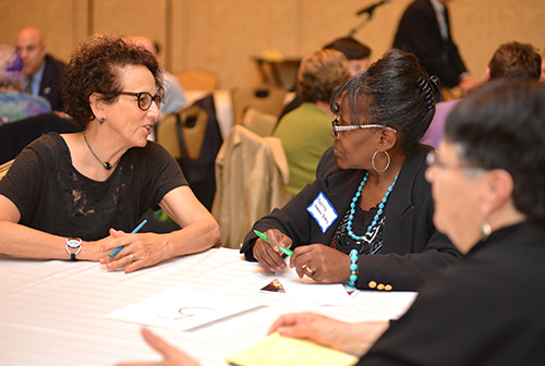 Yvette Harris-Evans and Sheila Cabral Sousa participate in a round-table policy discussion. 